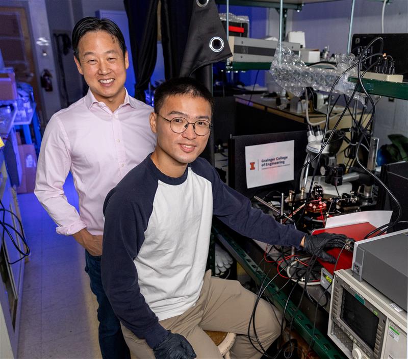 Larry Lee and Yiteng Wang stand at laboratory equipment