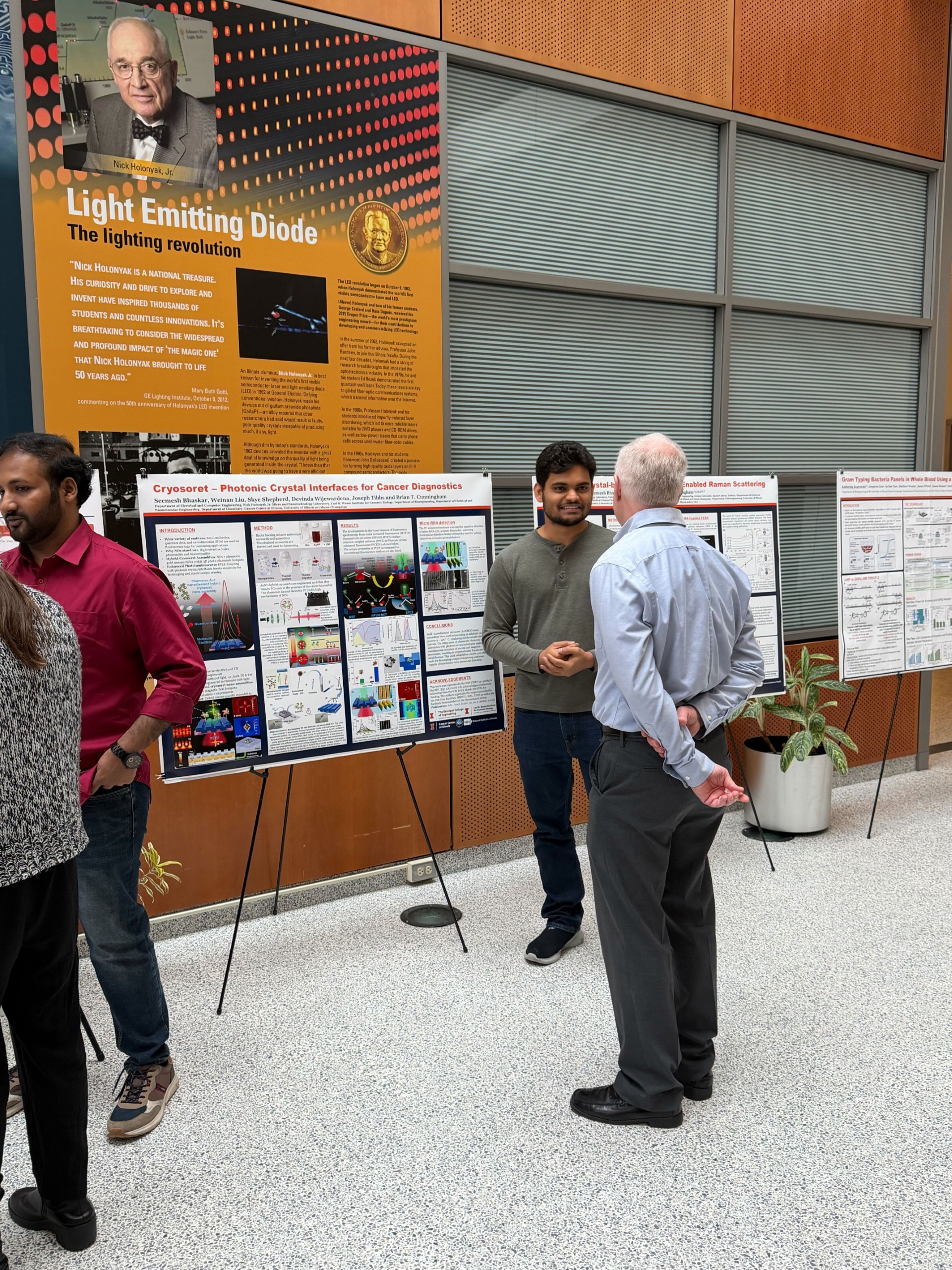 Seemesh Bhaskar talks with professor Brian Cunningham during poster session