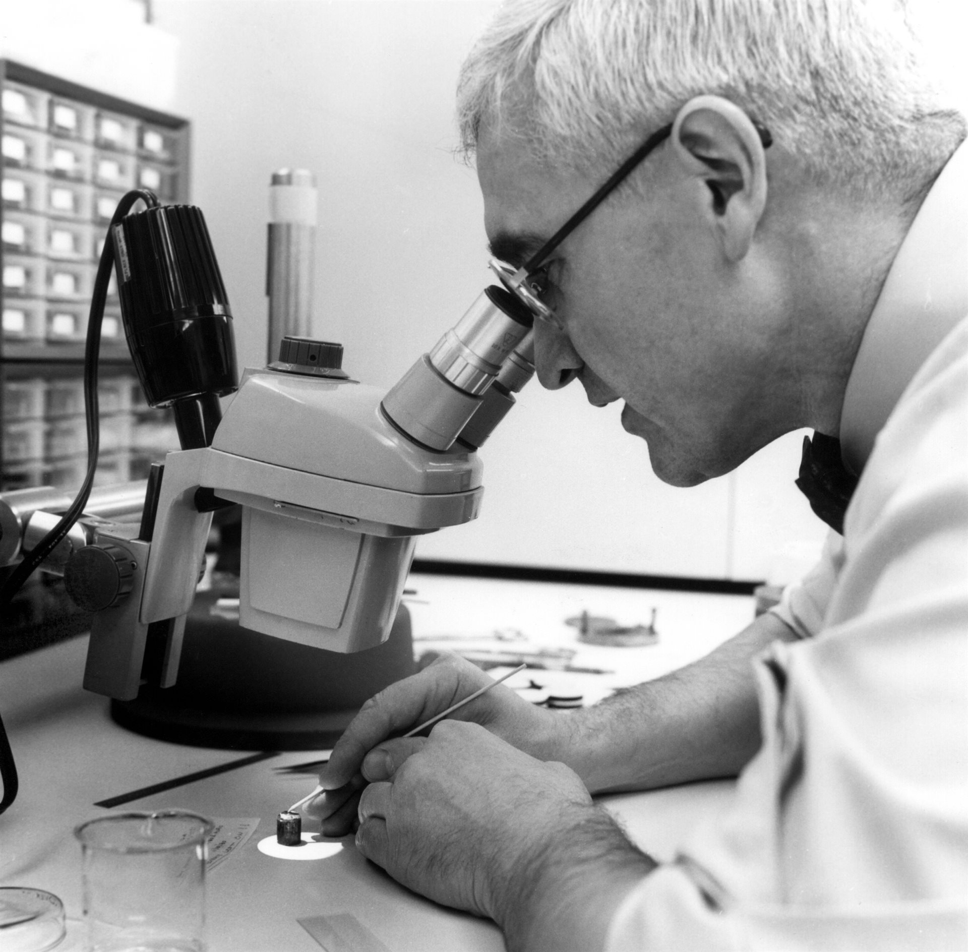 Nick Holonyak Jr. looking through a microscope