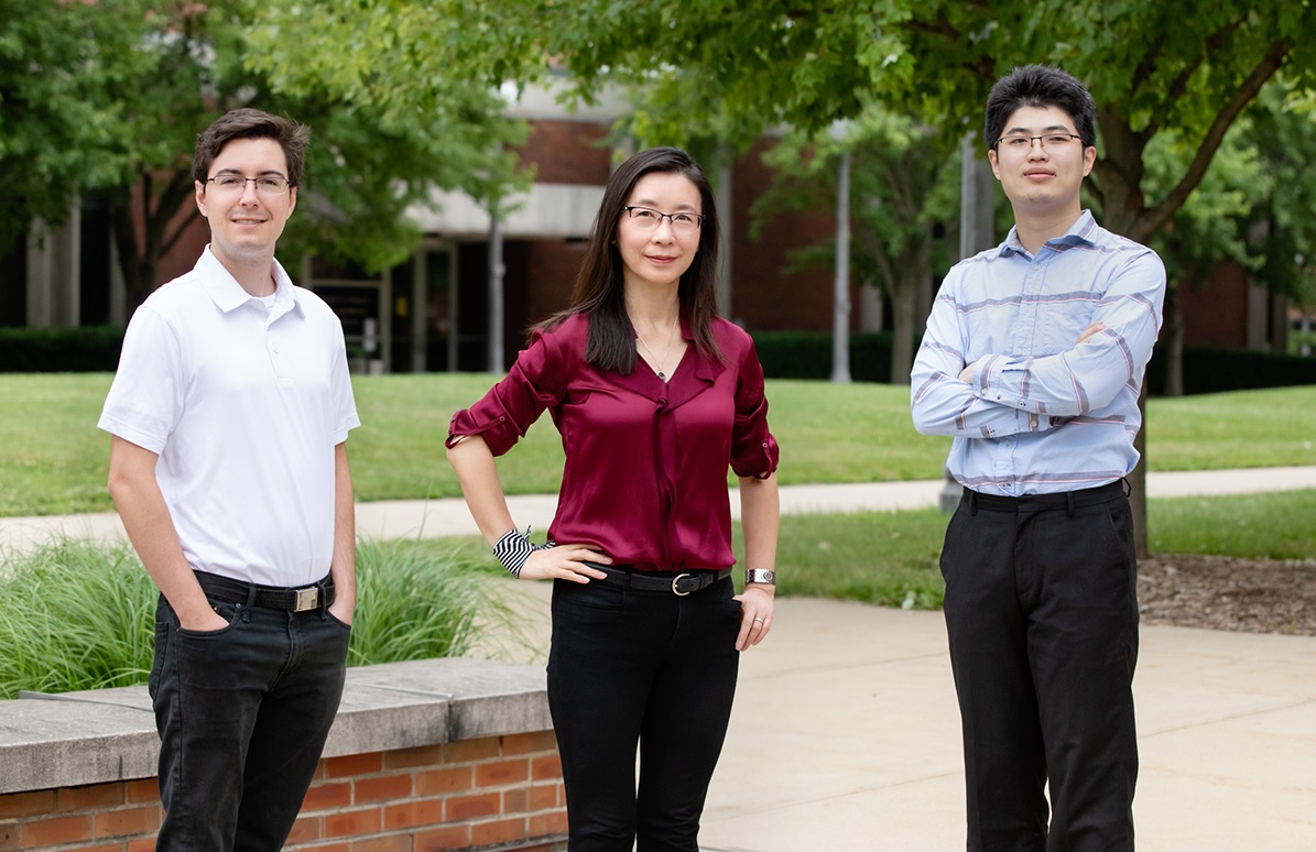 Mark Kraman, left, professor Xiuling Li, center, and Mike Yang, right, led a study that integrates the multiple elements needed for the electronic filters found inside wireless devices into a single, self-assembling and space-saving computer chip component.  Photo by L. Brian Stauffer