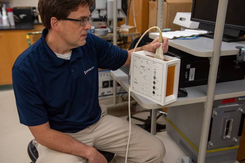 Michael Oelze with an ultrasound machine.