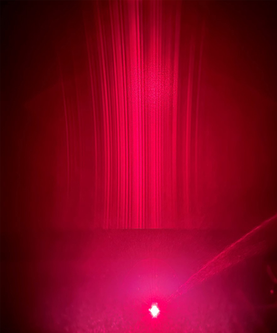 A light emitting red on a backdrop.