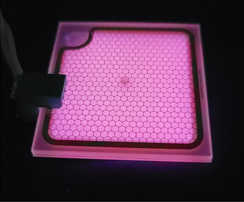 Photograph of a microplasma lamp peaking at 222-nm ultraviolet light for disinfection applications. The weak purple&amp;ndash;red glow is due to an impurity in the lamp.